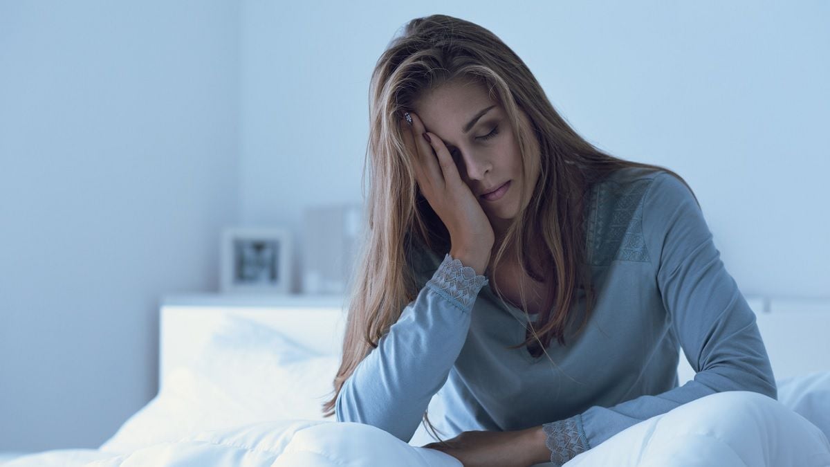 jeune femme fatiguée au réveil dans son lit