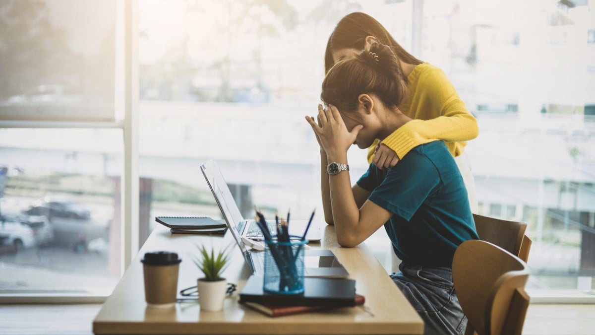 Une femme réconforte sa collègue au travail