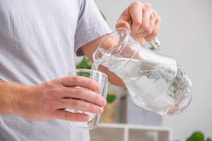 Un homme se sert un verre d'eau