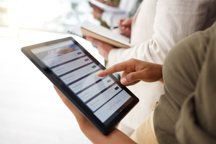 Une femme cherche un emploi sur une tablette