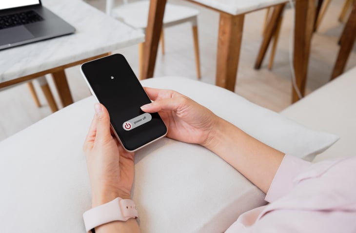 Une femme éteint son téléphone