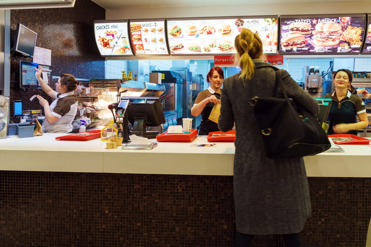 Un femme commande dans un fast-food