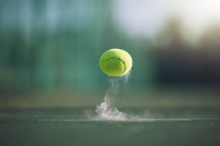 Une balle de tennis rebondit sur le sol