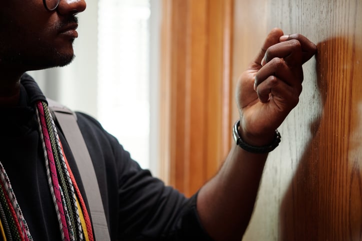 Un homme toque à la porte