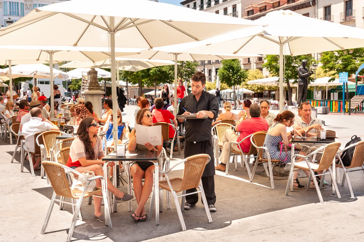 Un serveur sert des plats aux clients d'un restaurant