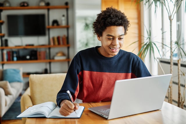 Un adolescent en train de faire ses devoirs