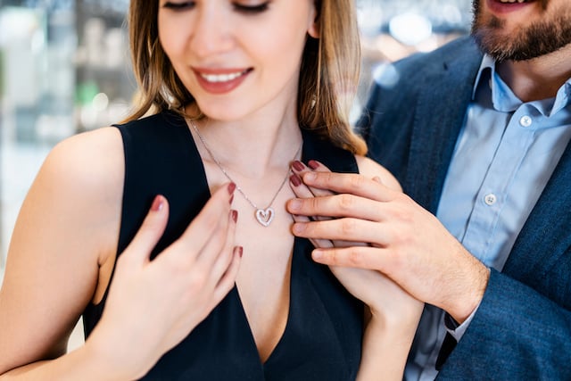 Un homme offrant collier à sa compagne