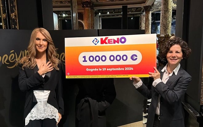 la gagnante du Keno posant derrière le chèque à côté d ela statue de cire de Céline Dion