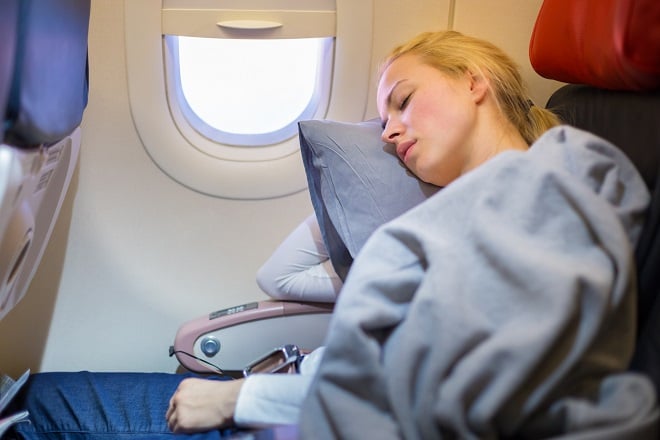 jeune femme faisant la sieste dans un avion